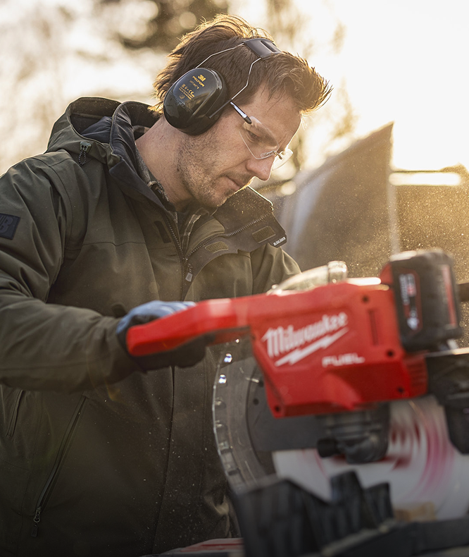 Person using a power tool outdoors